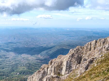 Mountain landscape from the top of Chatyrdag in Crimea. Blue sky and white clouds on the peak.の写真素材