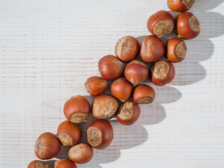 Fresh hazelnuts on wooden background.