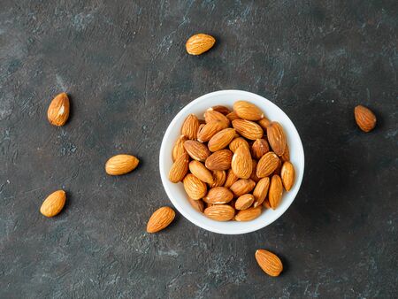 Almond nuts on wooden background. View of nuts without shell. Topview and copyspace for text.の写真素材