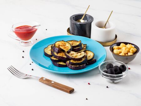 Fried aubergine in the blue plate.の写真素材