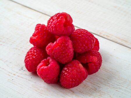 Fresh raspberry on wooden background.