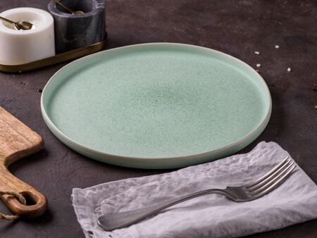 Empty green plate on dark background.の写真素材