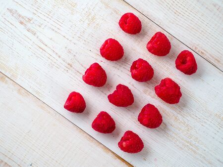 Fresh raspberry on wooden background.