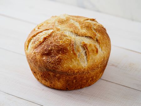 Loaf of bread on wooden background. Natural domestic bakery. Copyspace for text.の写真素材