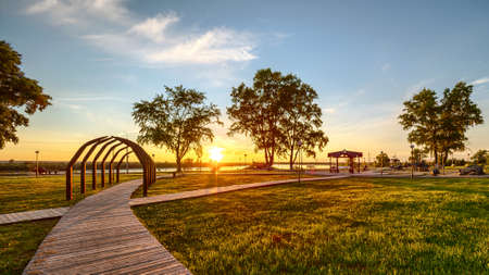 Sunset view of beautiful park in Kotlas city. Blue sky and green trees on the background.の写真素材