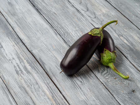 Young eggplants on wooden rustic background.の写真素材