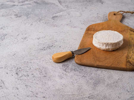 Traditional french cheese brie on wodden cutting board.の写真素材