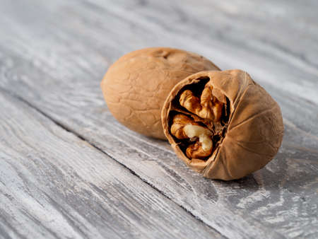 Walnut with shell on wooden background.の写真素材