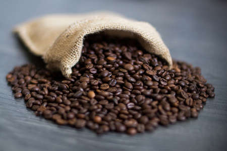the coffee grains which are pouring out from a bagの写真素材