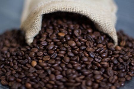 the coffee grains which are pouring out from a bagの写真素材