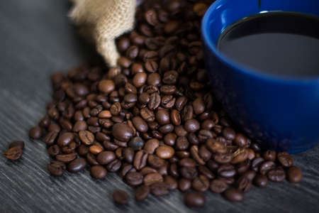 A cup of coffee on coffee beansの写真素材
