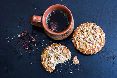 Herbal tea with biscuits on a textured black backgroundの写真素材