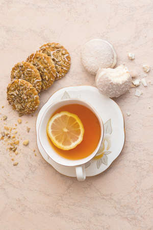 White cup of tea and saucer with shortbread biscuitsの写真素材