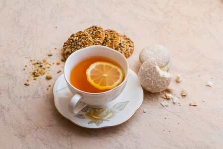 White cup of tea and saucer with shortbread biscuitsの写真素材