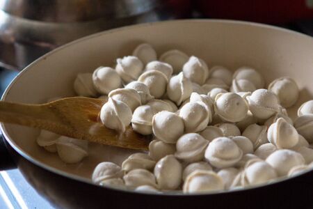 Fresh meat dumplings - cooking russian boiled pelmeniの写真素材