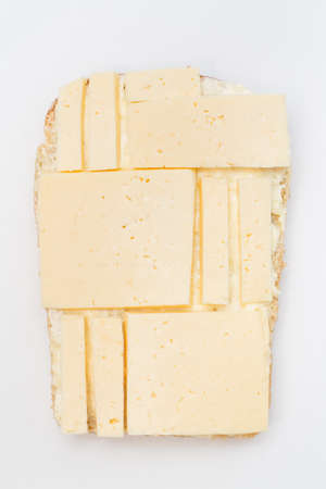 Cheese pieces on bread as geometrical figures
