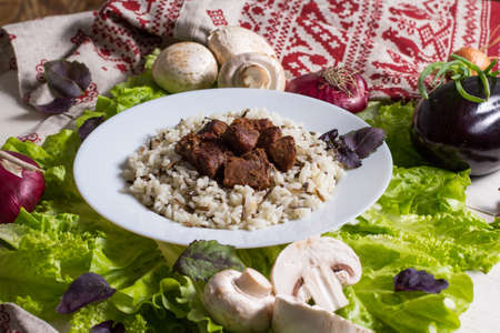still life - pork pieces with a garnish from brown riceの写真素材