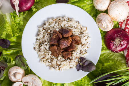 still life - pork pieces with a garnish from brown riceの写真素材