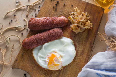 fried eggs with sausages and fried cabbage, rusticの写真素材