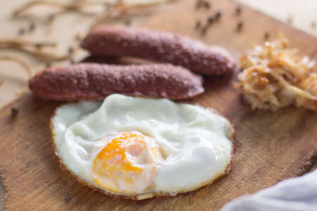 fried eggs with sausages and fried cabbage, rusticの写真素材