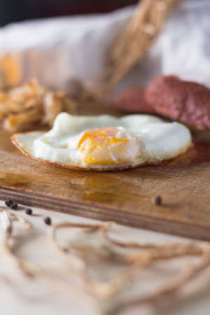 fried eggs with sausages and fried cabbage, rusticの写真素材