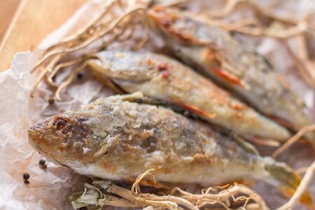 still life - pan fried perch on baking paperの写真素材
