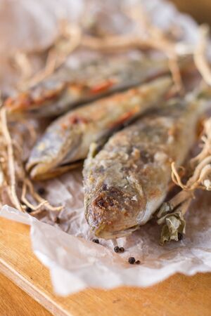 still life - pan fried perch on baking paperの写真素材
