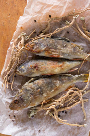 still life - pan fried perch on baking paperの写真素材
