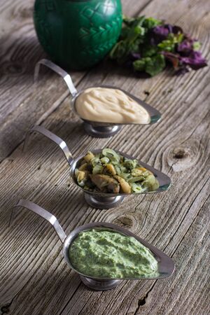 Different homemade sauce on an old wooden backgroundの写真素材