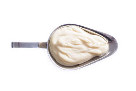 Homemade mayonnaise in a gravy boat on a white backgroundの写真素材
