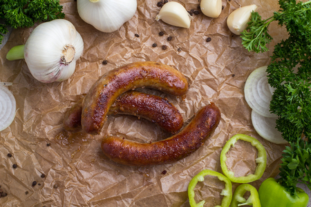 Grilled meat - sausages and vegetables with herbs and garlicの写真素材