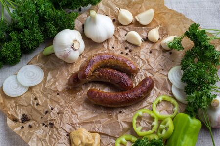 Grilled meat - sausages and vegetables with herbs and garlicの写真素材