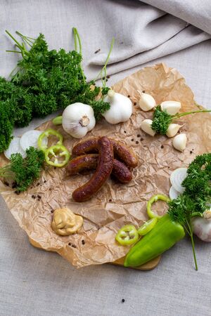 Grilled meat - sausages and vegetables with herbs and garlicの写真素材