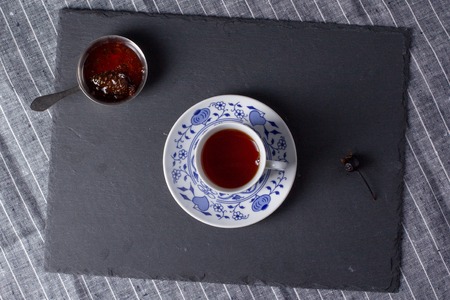Cup for tea, located on a black board, top viewの写真素材