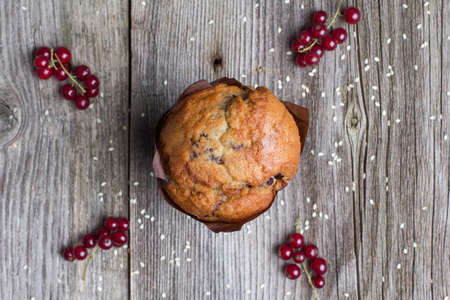 Fresh muffin with berries on the rustic table for breakfastの写真素材