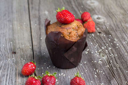 Fresh muffin with berries on the rustic table for breakfastの写真素材