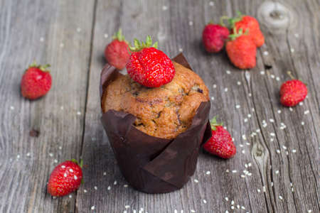 Fresh muffin with berries on the rustic table for breakfastの写真素材