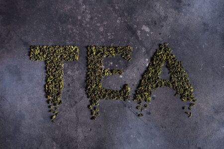 Written tea on a black background, letteringの写真素材