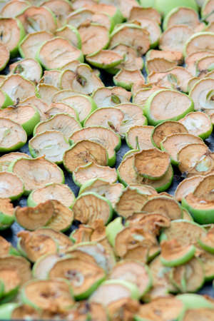 Dried slices of rustic apples as a textureの写真素材