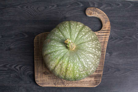 Still life - Green pumpkin on a wooden backgroundの写真素材
