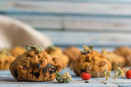 Fresh homemade delicious carrot muffins with raisins and dried fruits on a wooden backgroundの写真素材