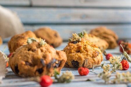 Fresh homemade delicious carrot muffins with raisins and dried fruits on a wooden backgroundの写真素材