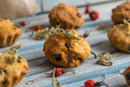 Fresh homemade delicious carrot muffins with raisins and dried fruits on a wooden backgroundの写真素材