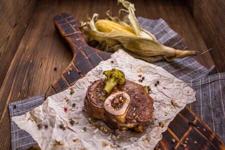 Baked lamb knee and close-up on a wooden boardの写真素材