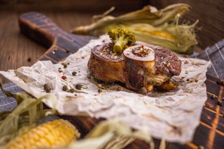 Baked lamb knee and close-up on a wooden boardの写真素材