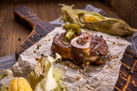 Baked lamb knee and close-up on a wooden boardの写真素材