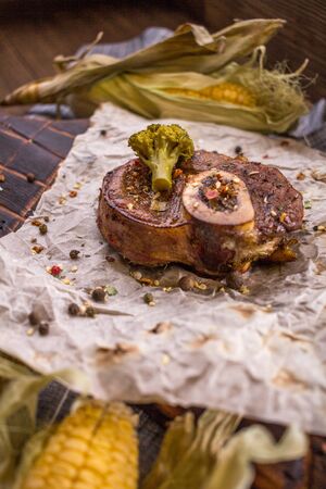 Baked lamb knee and close-up on a wooden boardの写真素材