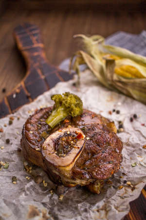 Baked lamb knee and close-up on a wooden boardの写真素材