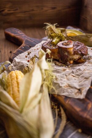Baked lamb knee and close-up on a wooden boardの写真素材