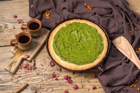 Still life - avocado pie in a frying pan on a wooden tableの写真素材